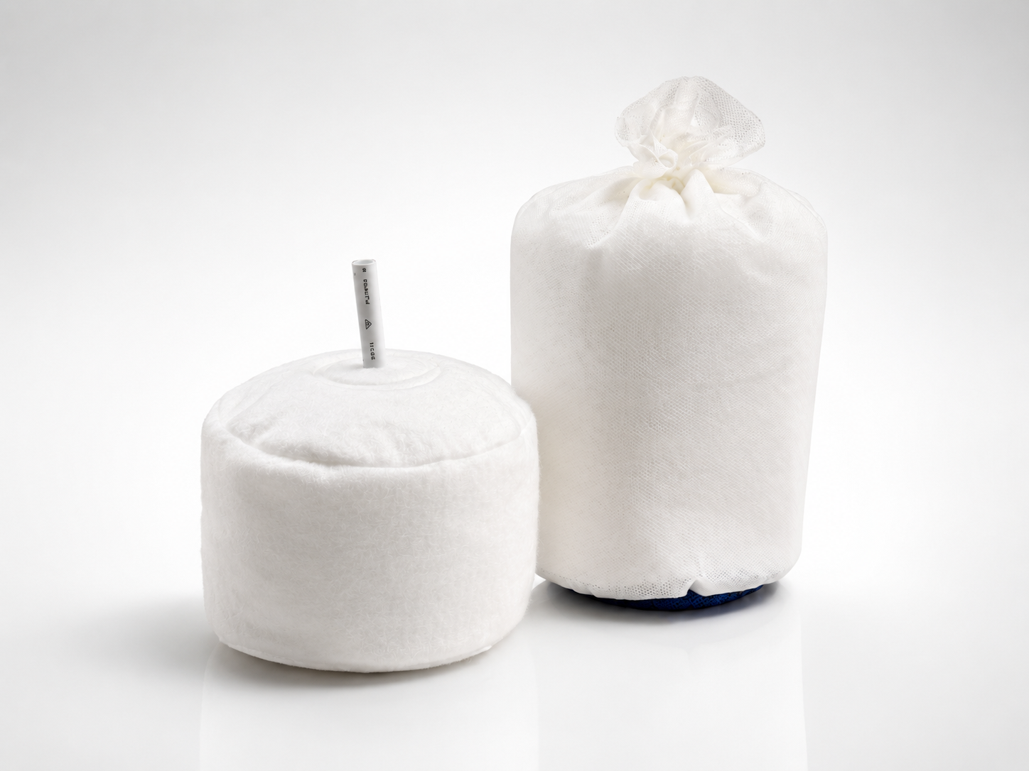Two white OWS service kits side-by-side, one with a gathered top and the other with a central tube.